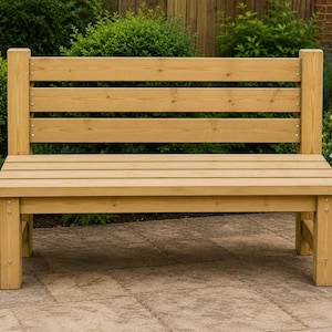 May include: A wooden outdoor bench with a natural finish. The bench features a slatted seat and backrest, supported by sturdy legs and vertical posts. The bench is surrounded by greenery.