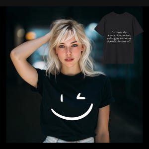 May include: Black t-shirt with a white smiley face graphic. A second black t-shirt is visible, displaying the text: "I'm basically a very nice person, as long as someone doesn't piss me off.."