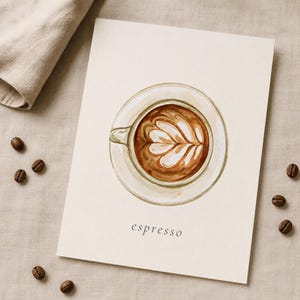 K&ouml;nnte beinhalten: Ein rechteckiger Druck auf cremefarbenem Papier mit einer Aquarellillustration einer Kaffeetasse mit Latte-Art-Muster in der Mitte. Der Kaffee ist braun mit wei&szlig;em Milchschaum. Das Wort espresso ist darunter in schwarzer Schrift gedruckt.