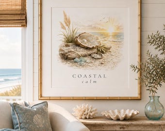May include: A square framed print in a gold bamboo-style frame featuring a watercolor illustration of an oyster shell with a pearl on a sandy beach, driftwood, and tall grass at sunset. The text COASTAL calm is printed below the illustration.