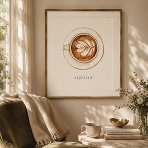 K&ouml;nnte beinhalten: Ein gerahmter Kunstdruck mit einer Aquarellillustration einer Kaffeetasse in der Draufsicht mit Latte Art in Braun- und Cremet&ouml;nen. Das Wort espresso ist in schwarzen Kleinbuchstaben unter der Tasse auf hellbeigem Hintergrund gedruckt.