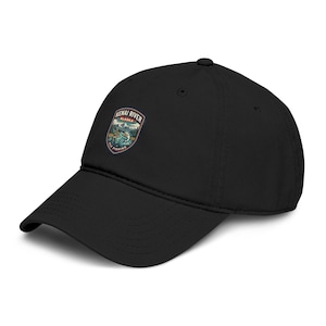 May include: Black baseball cap with a curved brim. The cap features a patch with the text "Kenai River Alaska Fly Fishing" and a scenic illustration of a river and mountains.