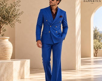 May include: A vibrant blue double-breasted suit with white pinstripes, featuring gold buttons and a dark burgundy shirt underneath. The suit includes a matching blazer and wide-leg trousers. The Dapper Tux logo is visible in the top right corner.