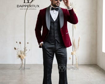 May include: A burgundy velvet tuxedo jacket with grey shawl lapels, a black waistcoat, a white dress shirt with a black bow tie, and black flared trousers. The ensemble features the DAPPERTUX logo and text printed in the upper left corner.