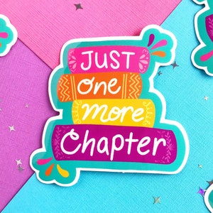 May include: A set of four colorful stickers with the text "Just one more chapter" on a stack of books. The stickers are on a pink and blue background with silver glitter.