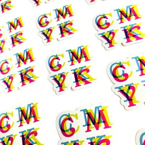 May include: A set of colorful stickers with the letters "CMYK" printed in a layered, overlapping design. The letters are printed in cyan, magenta, yellow, and black.