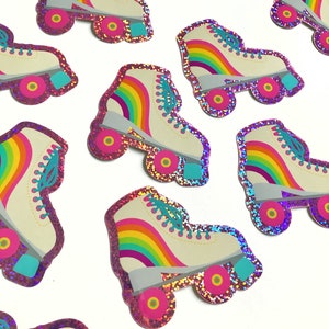 May include: A set of 10 rainbow roller skate stickers with pink glitter borders. The stickers are white with a rainbow stripe and turquoise laces.