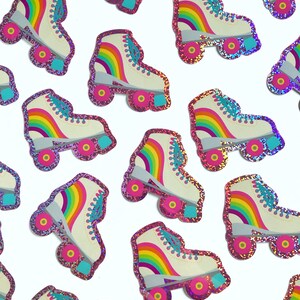 May include: A collection of rainbow roller skate stickers with pink glitter accents. The stickers feature a white base with a rainbow design and pink glitter around the edges.