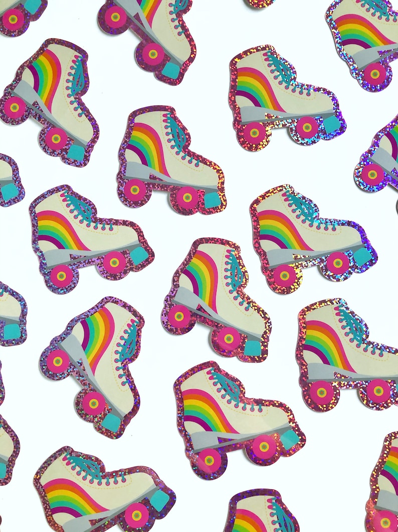 May include: A collection of rainbow roller skate stickers with pink glitter accents. The stickers feature a white base with a rainbow design and pink glitter around the edges.