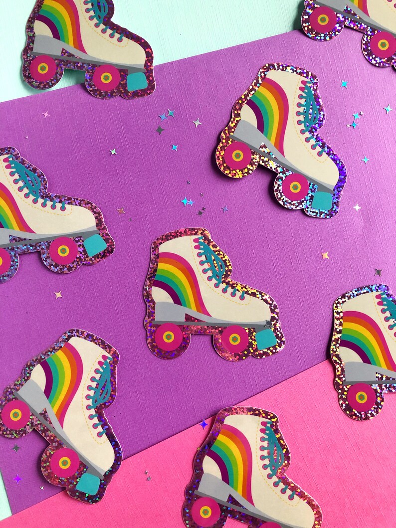 May include: A set of eight rainbow roller skate stickers. The stickers are made of glitter paper and have a white background with a rainbow stripe across the top. The stickers are perfect for adding a touch of fun to your laptop, water bottle, or planner.