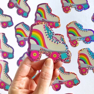 May include: A set of rainbow roller skate stickers with pink glitter. The stickers are perfect for decorating laptops, water bottles, and other surfaces.