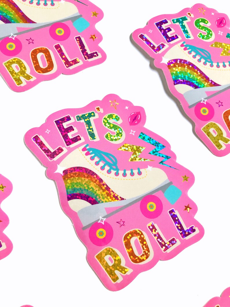 May include: Pink sticker with a rainbow roller skate and the text "Let's Roll" in glittery letters.