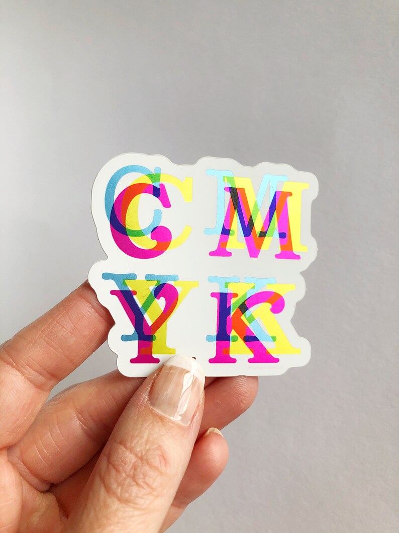 May include: A sticker with the letters CMYK in a layered, overlapping design. Each letter is made up of different colors, including cyan, magenta, yellow, and black.