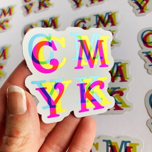 May include: A set of four colorful CMYK stickers with a white background. The letters are layered and overlapping, creating a 3D effect. The colors are cyan, magenta, yellow, and black.