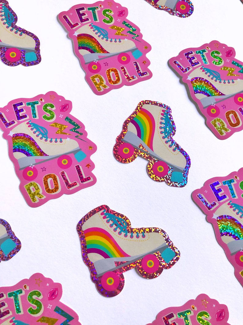 May include: Pink and white roller skate stickers with rainbow accents and glitter. The stickers say "Let's Roll" in a colorful font.
