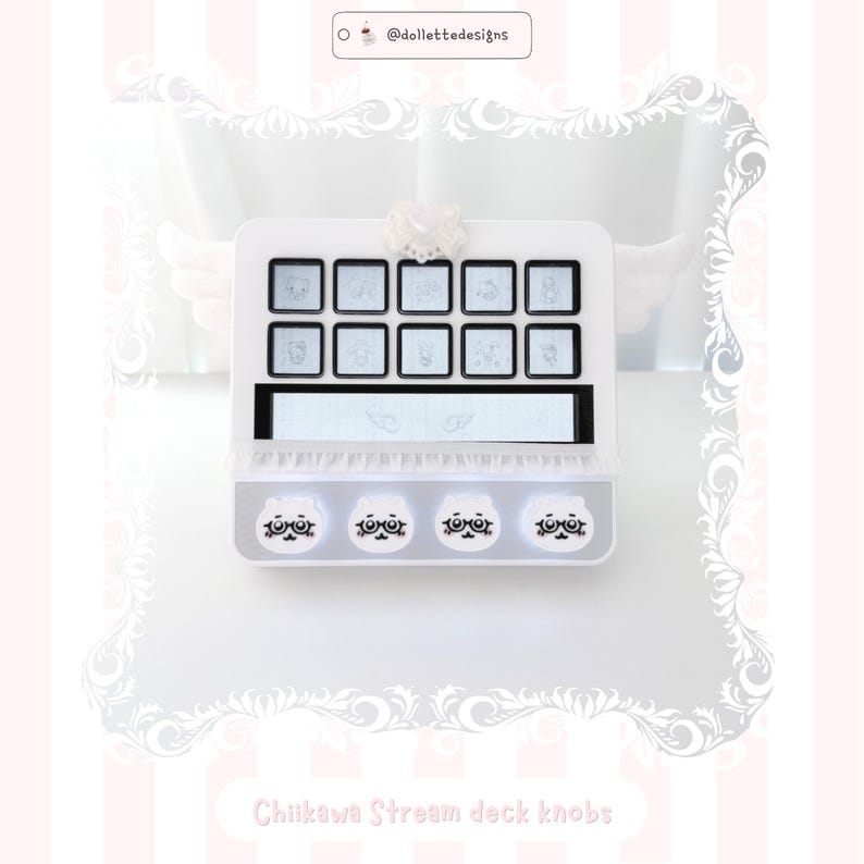May include: A white stream deck featuring ten square buttons with light gray character illustrations, a horizontal display screen with wing graphics, and four circular knobs at the bottom decorated with white cartoon faces wearing glasses.