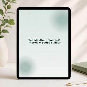 May include: A black tablet displays the text "Tell Me About Yourself Interview Script Builder" on a white and green gradient background. A white pen with gold accents, a green book, and a beige vase with greenery are also visible.