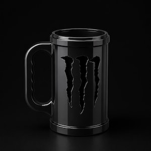 May include: A glossy black cylindrical mug featuring a large, vertical, claw-mark style cutout logo on the front. The mug has a thick, sturdy handle with a wavy inner grip and raised rim details at the top and bottom, presented against a dark background.
