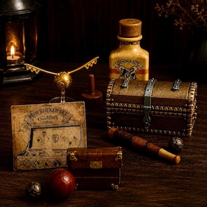 May include: A Quidditch-themed collection featuring a gold winged ball on a stand, a Hogwarts-labeled bottle, a brown treasure chest with silver accents, a wooden bat, a small brown trunk, a red ball, and a Deco Sticker Set Quidditch Box card.