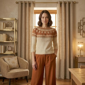 May include: A three-quarter sleeve knit sweater featuring a cream-colored body and a yoke decorated with a brown and white geometric pattern, paired with solid rust-colored wide-leg trousers that have a high waist and a pleated front design.