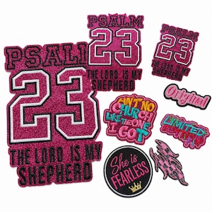 May include: A collection of pink glitter patches with various designs and text. Several patches feature the number 23 and the phrase "Psalm 23, The Lord is my Shepherd." Other patches include "Ain't No Church Like The One I Got," "Original," "Limited Edition," and "She is Fearless."