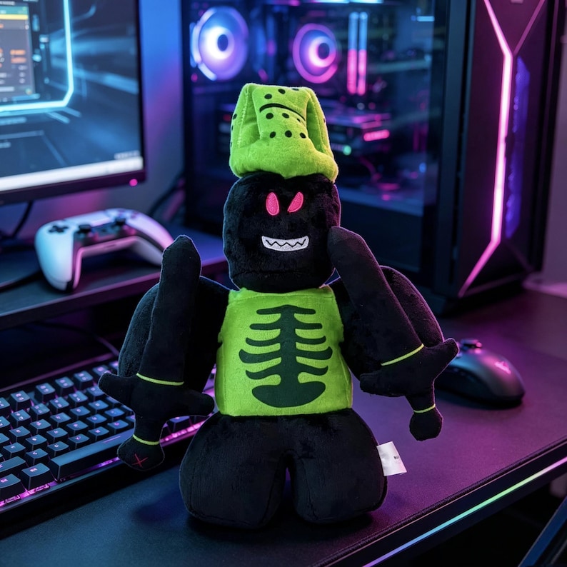 May include: A plush toy featuring a black character with a lime green helmet and a matching chest piece displaying a dark green ribcage graphic. The character has bright pink eyes, a white jagged mouth, and holds two black swords in its hands.
