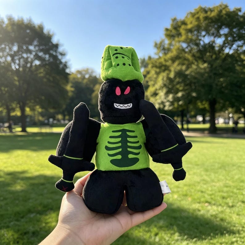 May include: A plush toy featuring a black character with a lime green helmet and a lime green torso decorated with a black ribcage graphic. The character has bright pink eyes, a white jagged mouth, and holds a black sword in each hand.