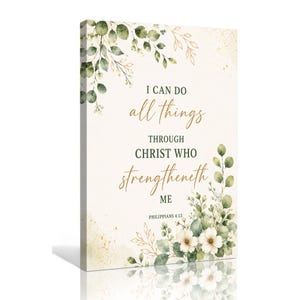 Peut inclure: Une toile murale rectangulaire sur fond crème ornée de feuilles d'eucalyptus vertes et de fleurs blanches. Le texte indique : I CAN DO all things THROUGH CHRIST WHO strengtheneth ME PHILIPPIANS 4:13 en lettres noires et dorées.