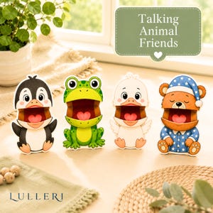 May include: Four paper cutouts of a penguin, frog, duck, and bear with open mouths showing a heart shape inside. A green sign with the text Talking Animal Friends and a heart icon is above them. The word LULLERI is printed at the bottom left.