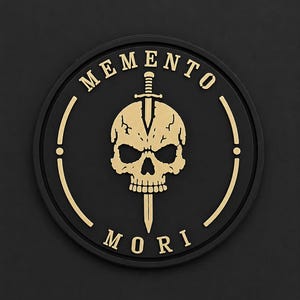 May include: A circular black patch featuring a gold-coloured skull pierced by a vertical sword. The text MEMENTO is arched above the skull, and the text MORI is positioned below it. The design is rendered in a high-contrast, raised relief style.