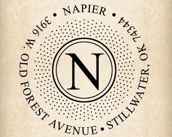 May include: Circular design with the letter "N" inside a circle, surrounded by text. The text includes the name "Napier", address "3916 W. Old Forest Avenue", and city "Stillwater, OK 74344". The design is in black on a beige background.