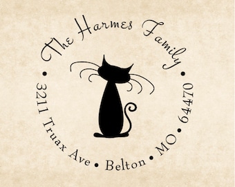 May include: Black and white return address stamp with a silhouette of a cat and the text "The Harmes Family", "3211 Truax Ave", "Belton, MO 64470".