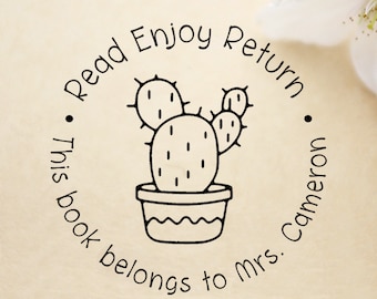 May include: Black and white illustration of a cactus in a pot with the text "Read Enjoy Return This book belongs to Mrs. Cameron".