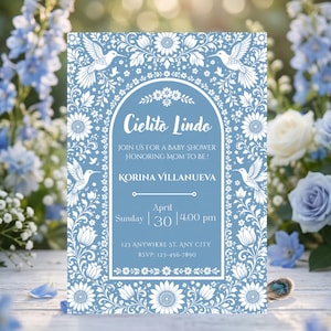 Könnte beinhalten: Eine rechteckige Babyparty-Einladungskarte mit hellblauem Hintergrund und einem weißen, detaillierten Blumen- und Kolibri-Rand. Der Text lautet Cielito Lindo, Join us for a baby shower honoring mom to be, Korina Villanueva, Sunday April 30 4:00 pm, 123 Anywhere St. Any City, RSVP: 123-456-7890.