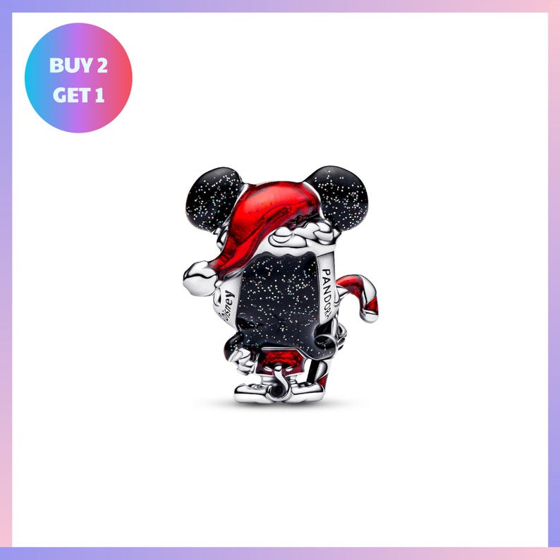 A silver and black charm in the shape of a cartoon character, possibly a character from Disney or a similar franchise, wearing a red hat and holding a red cane.