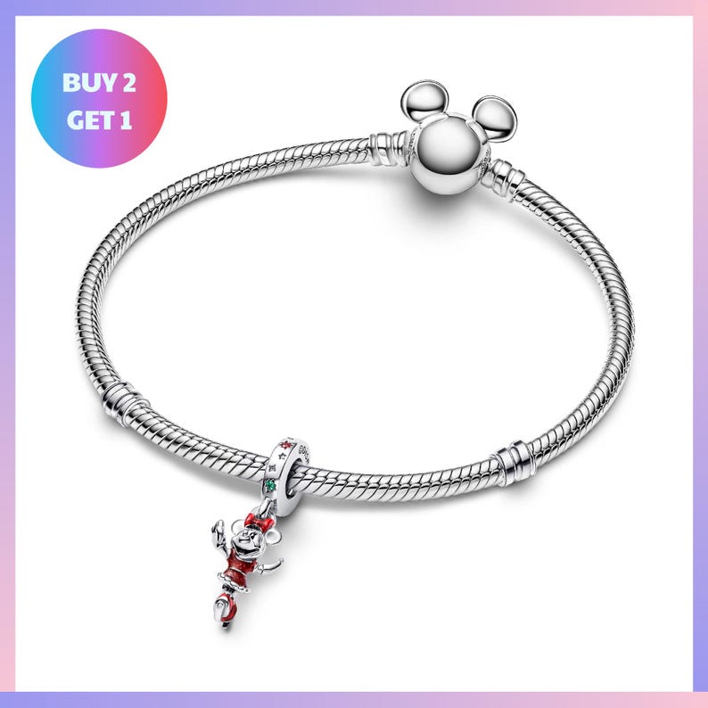 A silver bracelet with a charm featuring a cartoon character, likely Mickey Mouse, and a tag that says "BUY 2 GET 1".