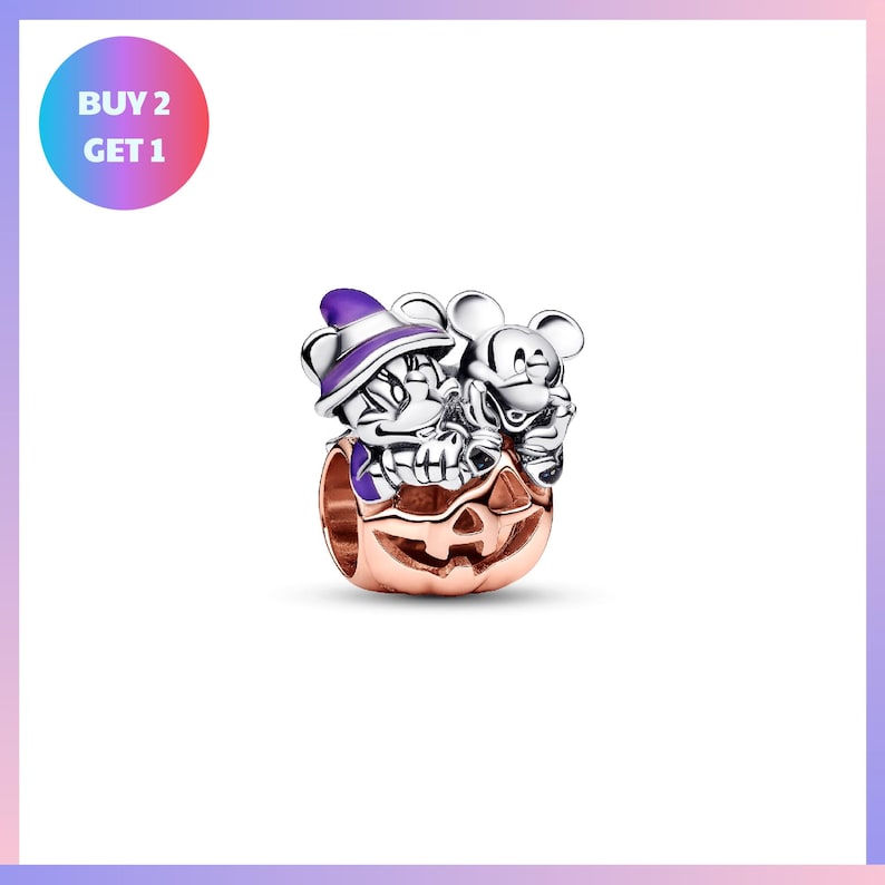 A silver charm bracelet with a pumpkin and two cartoon mice on it, set against a white background.