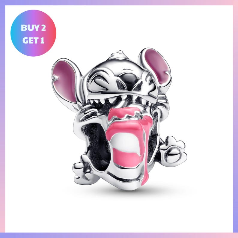 A silver charm in the shape of a cartoon character with a pink tongue sticking out, sitting on its hind legs.