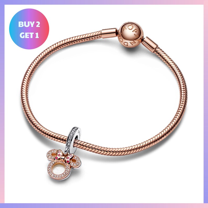 a bracelet with a charm and a textured metal frame.