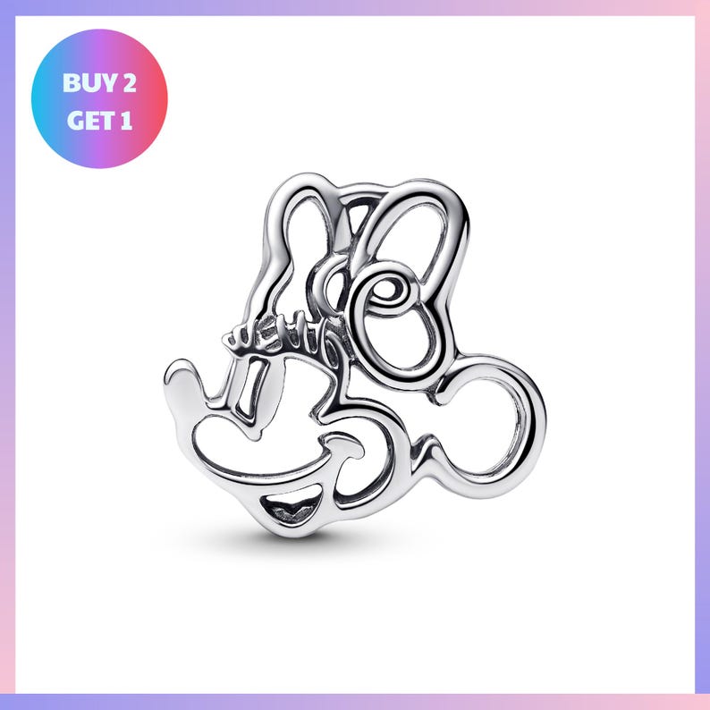 A silver-colored charm in the shape of a stylized letter "M" or a similar design, with a price tag indicating a "BUY 2 GET 1" offer.