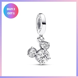 A silver charm bracelet with a pendant featuring a group of three sparkling diamonds.