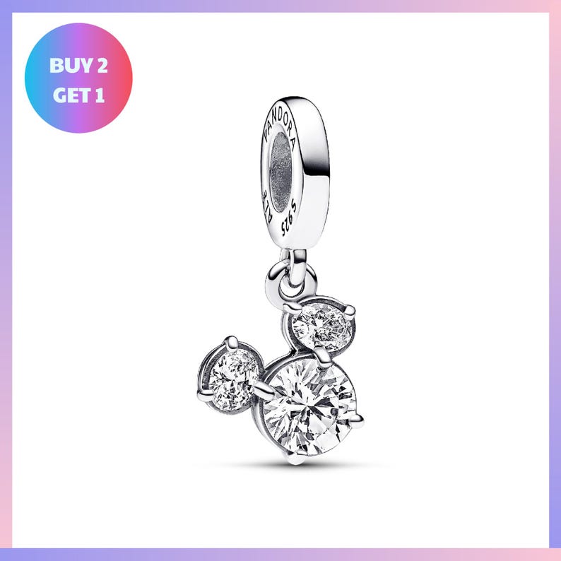 A silver charm bracelet with a pendant featuring a group of three sparkling diamonds.