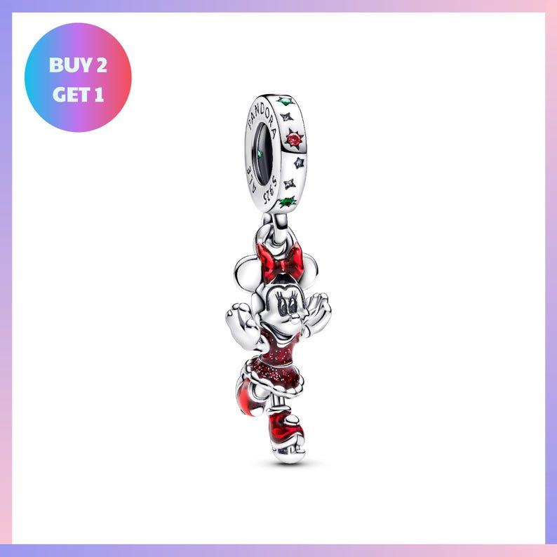 A silver charm in the shape of Minnie Mouse, wearing a red dress, is displayed against a white background.