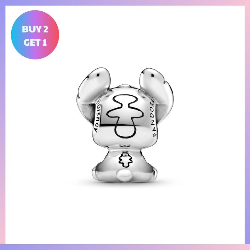 A silver-colored charm in the shape of a small animal, possibly a rabbit or a bunny, with a stylized design on its face.