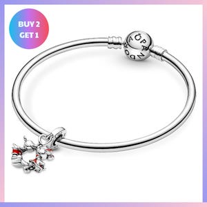 a silver-colored bracelet with a charm and a bead. The bracelet has a circular design and is displayed against a white background.
