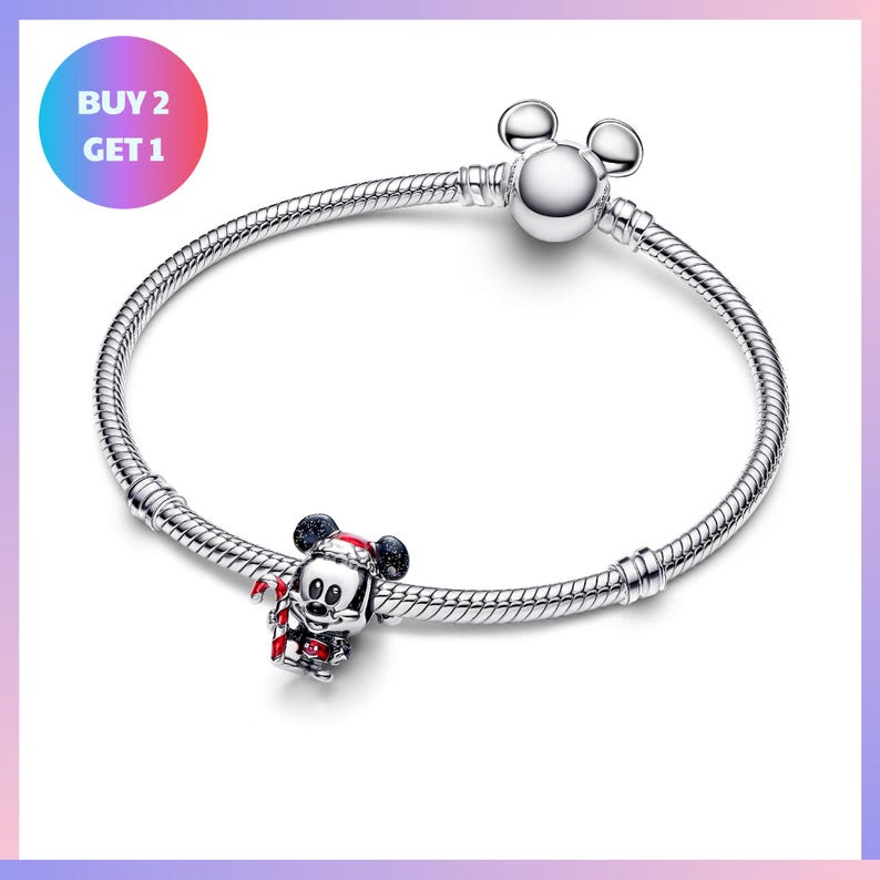 A silver bracelet with a charm featuring a cartoon character, likely Mickey Mouse, and a tagline that says "BUY 2 GET 1".