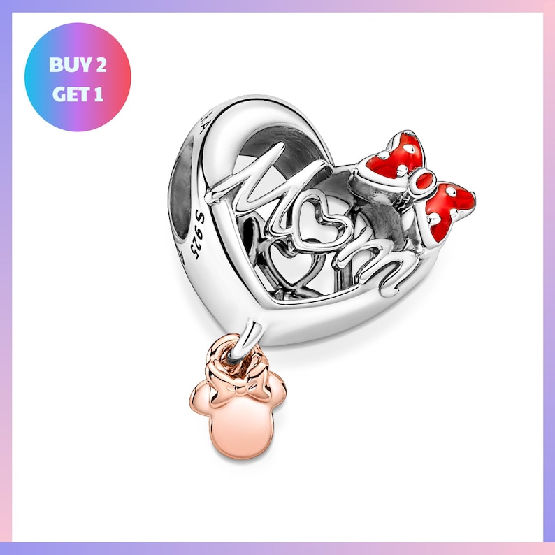 a silver heart-shaped charm with the word "MOM" written on it, along with two red bows. The charm is accompanied by a small pink charm that appears to be a baby's foot.