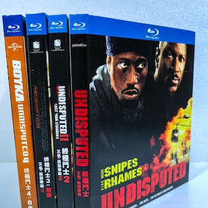 May include: A stack of Blu-ray movie cases featuring the "Undisputed" film series. The cases are black, orange, and blue, with images of actors and movie titles in English and Chinese characters. The "Undisputed" title is prominently displayed.
