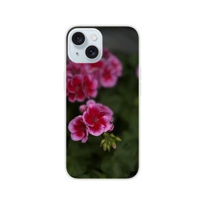 May include: A phone case featuring a close-up of vibrant pink geranium flowers with dark green foliage. The flowers have multiple petals and a darker pink center. The phone case has a white border.