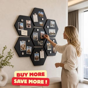 May include: A set of six black hexagonal magnetic boards arranged in a honeycomb pattern on a wall, featuring various photographs and notes attached with silver circular magnets. The boards are mounted together to create a large display surface.
